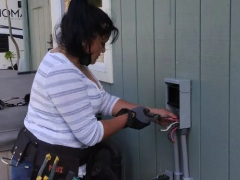 Licensed electrician wiring an exterior subpanel in Kaser