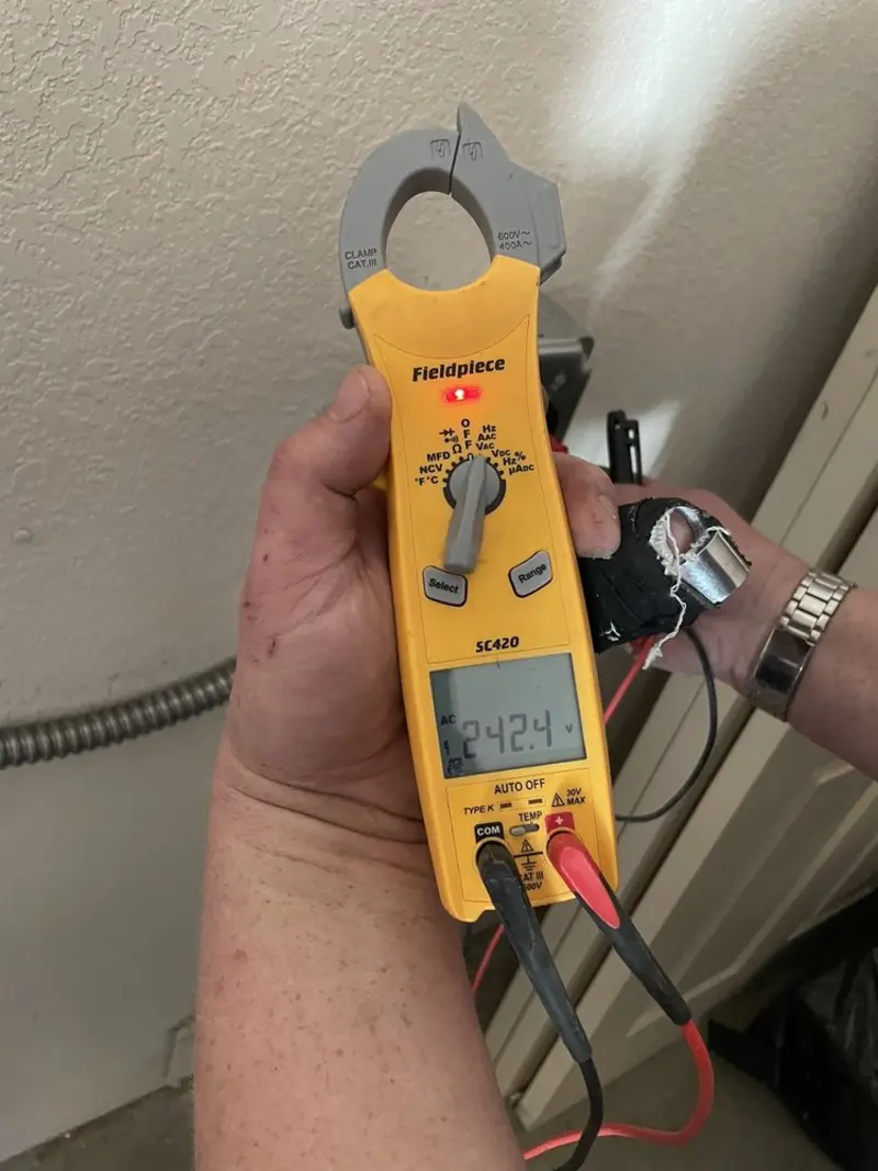 Voltage testing with clamp meter during Recessed Lighting Installation in Kaser